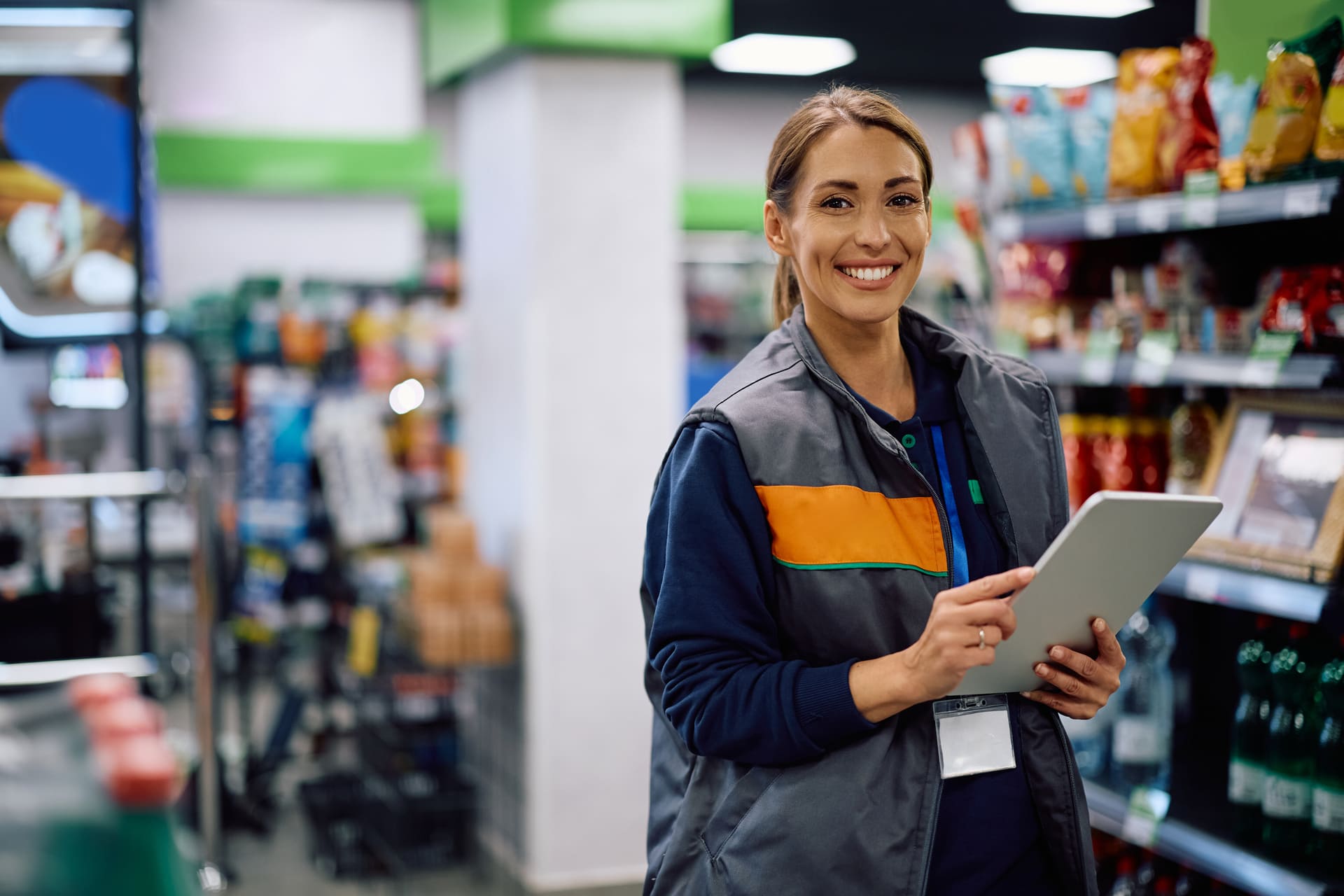 Female supermarket manager holding tablet in store