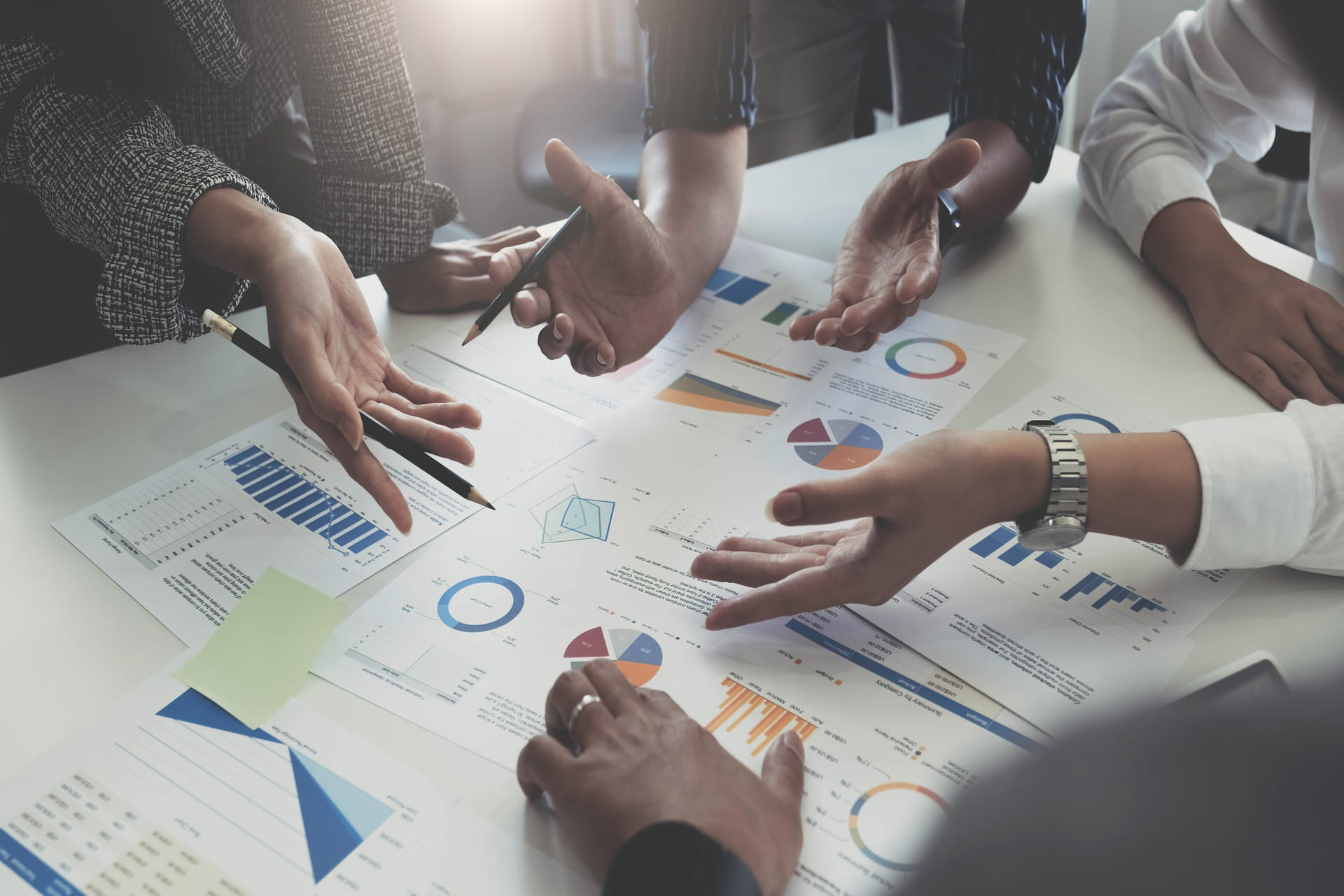 Team discussing financial charts and graphs during a business meeting