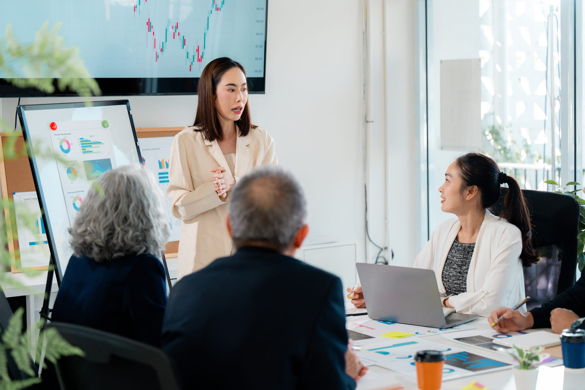 Team presentation with charts and graphs in office
