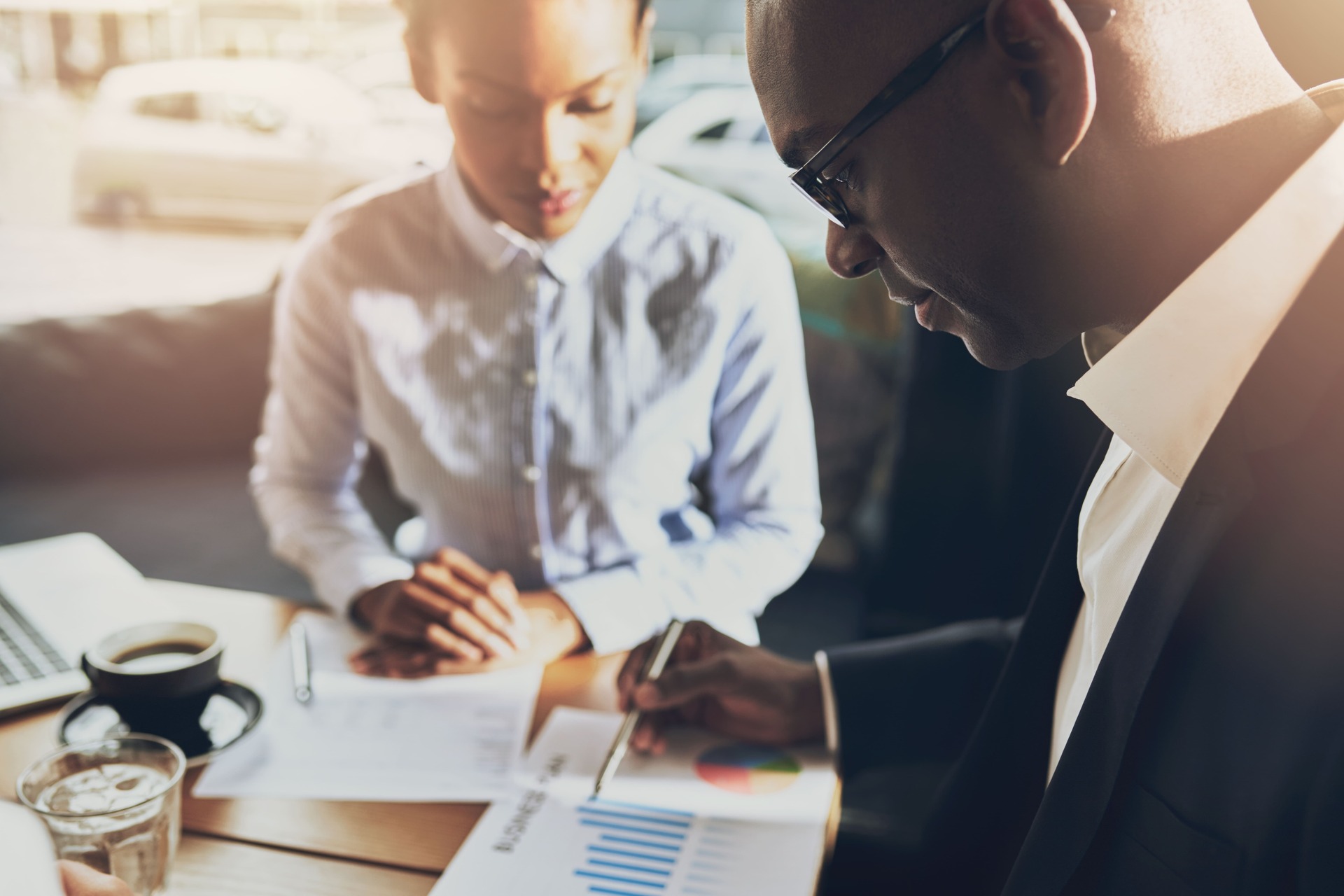 business-professionals-review-charts-at-table-indoor