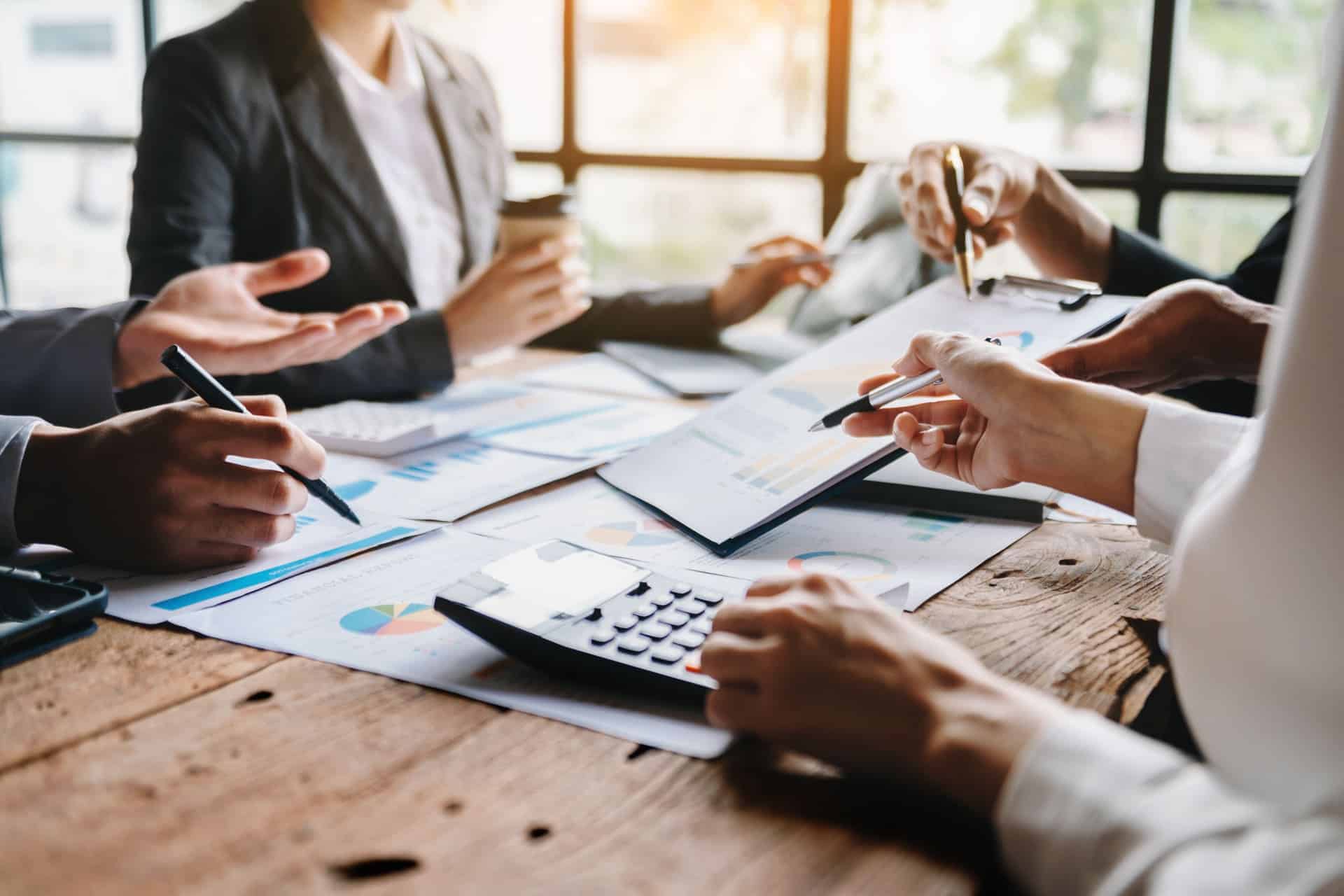 business-team-discussing-charts-and-graphs-at-meeting