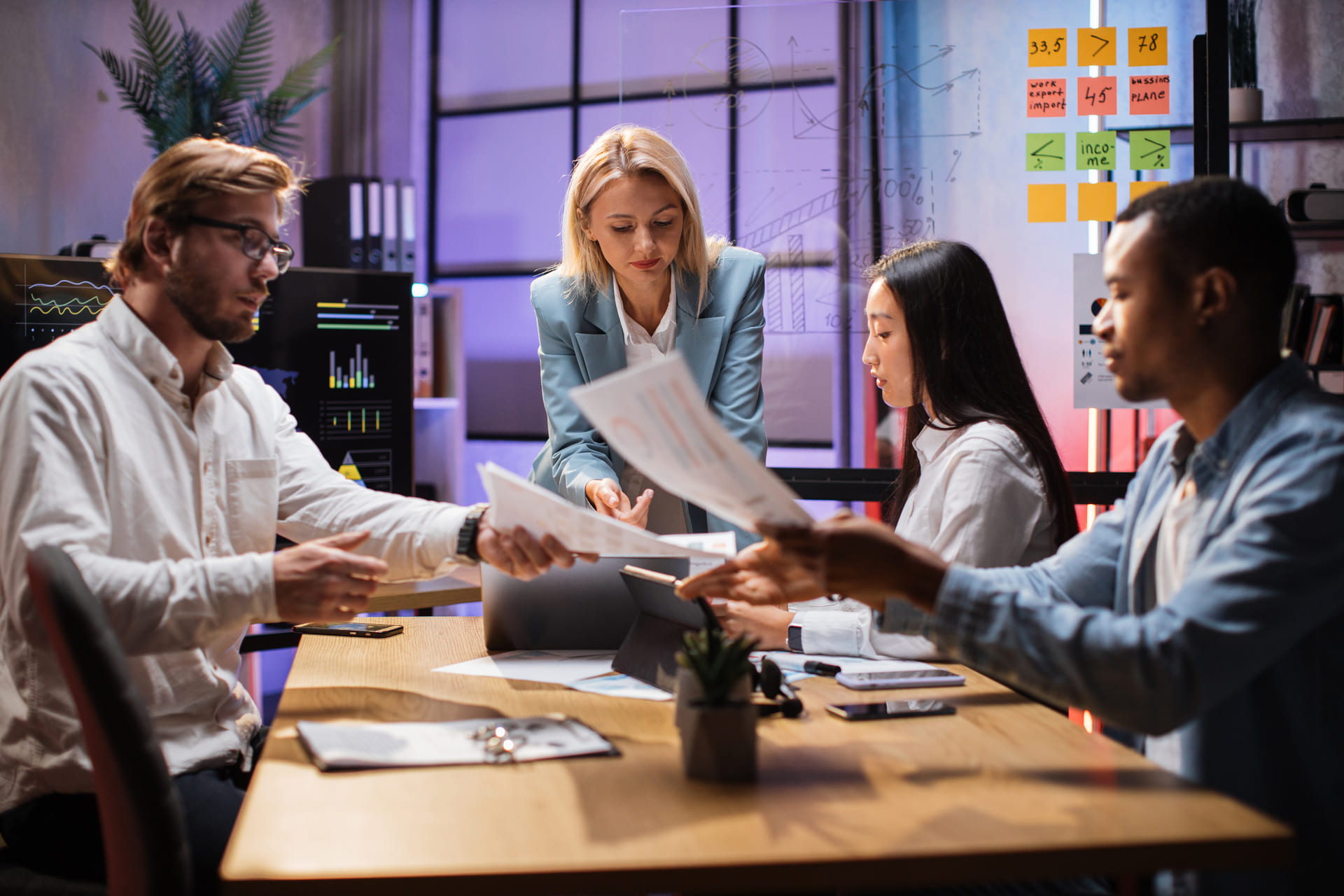 diverse-financiers-examining-company-statistics-at-office desk