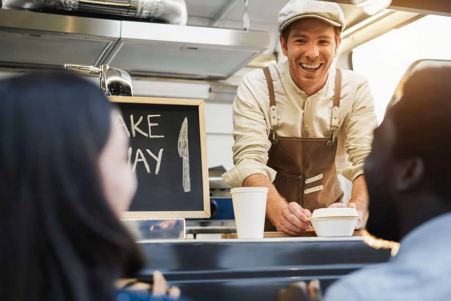 friendly-food-truck-vendor-serving-happy-customers