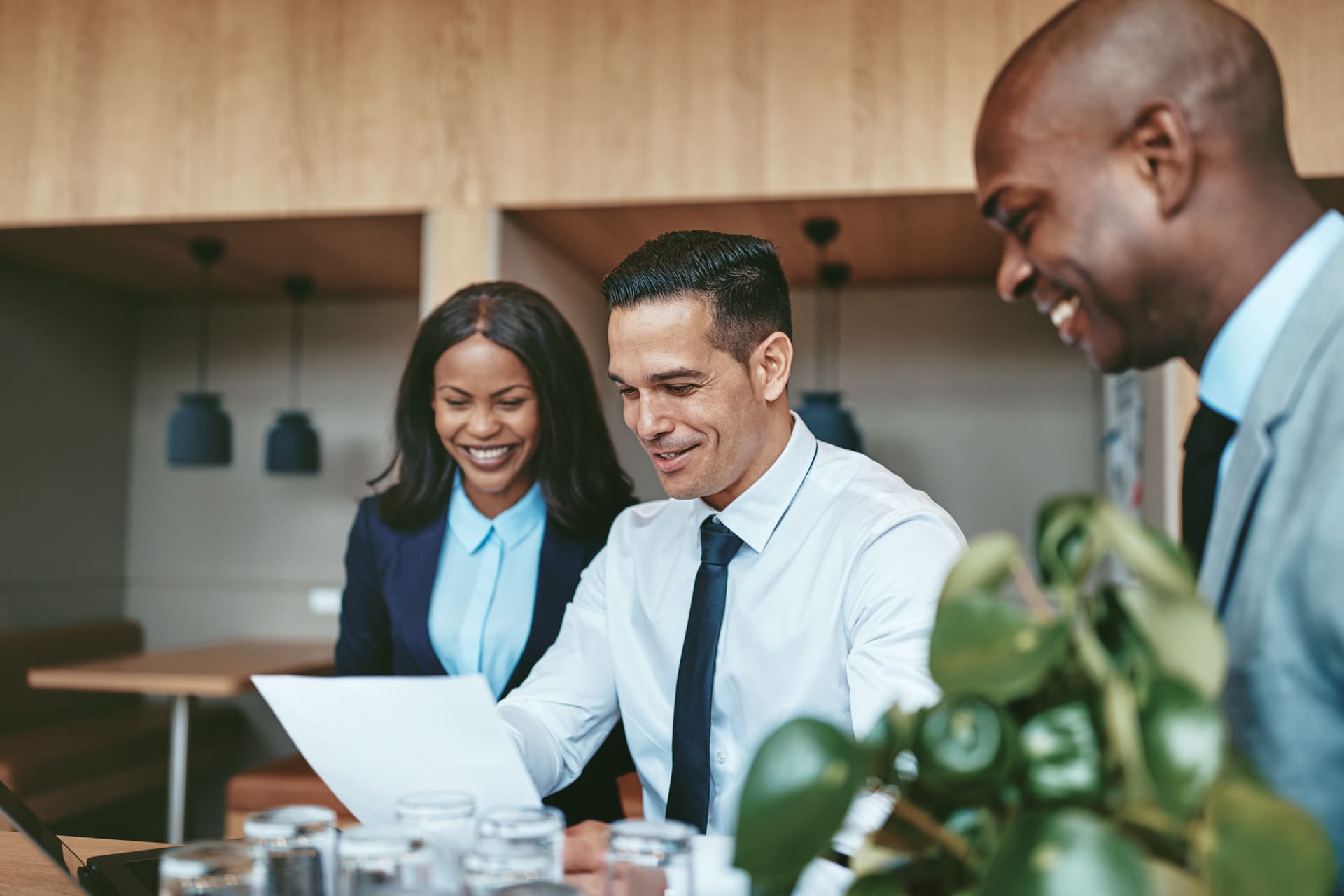 happy-professionals-reviewing-documents-at-modern office
