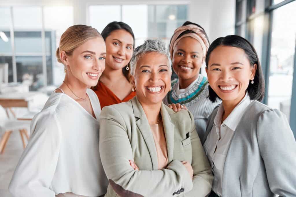 Group-of-professional-women-smiling-together-in-modern-office