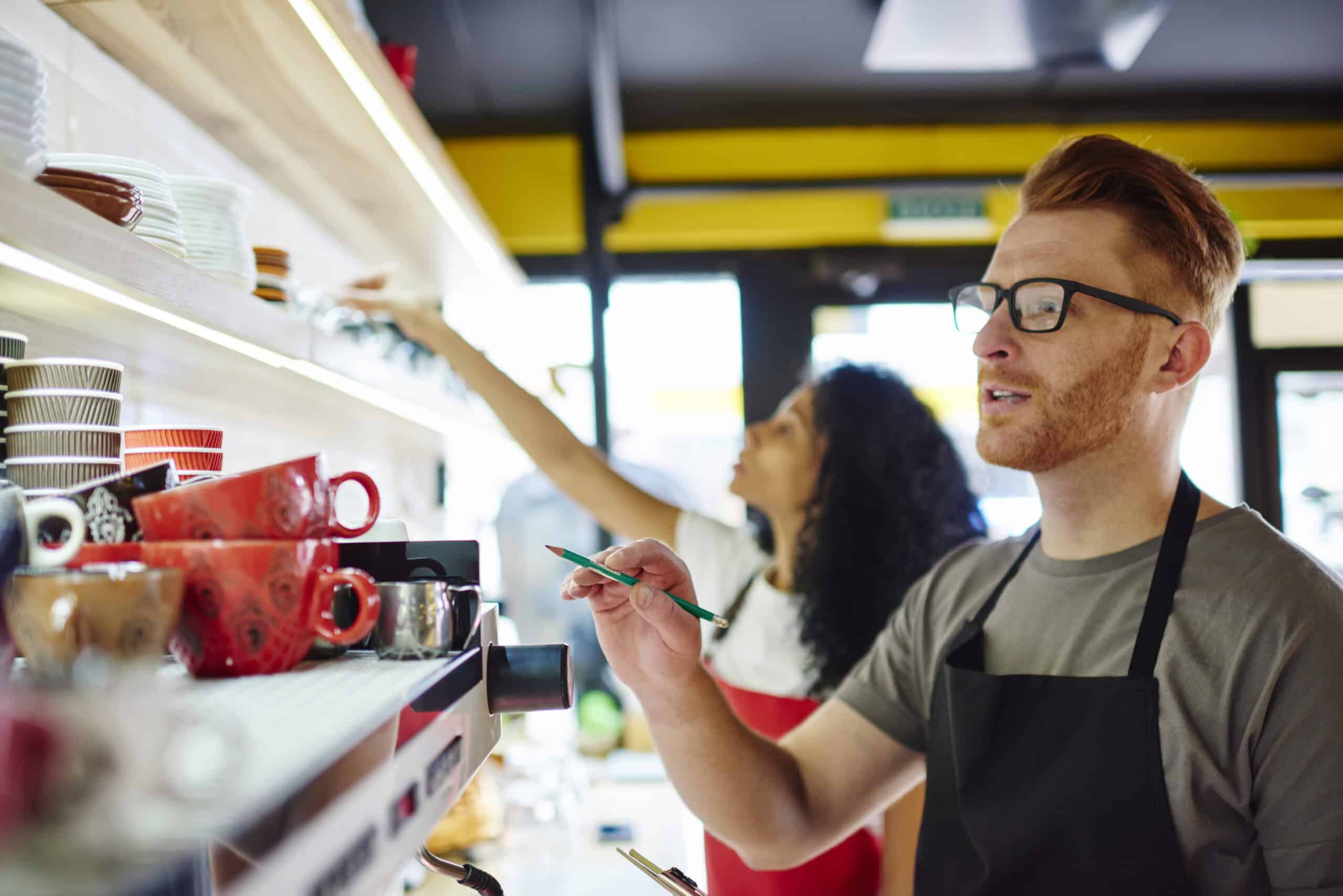 cafe-worker-taking-inventory-with-another-barista