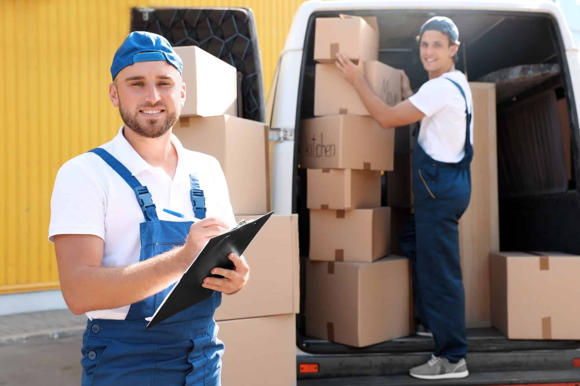 delivery-men-loading-boxes-into-truck-in-urban-set