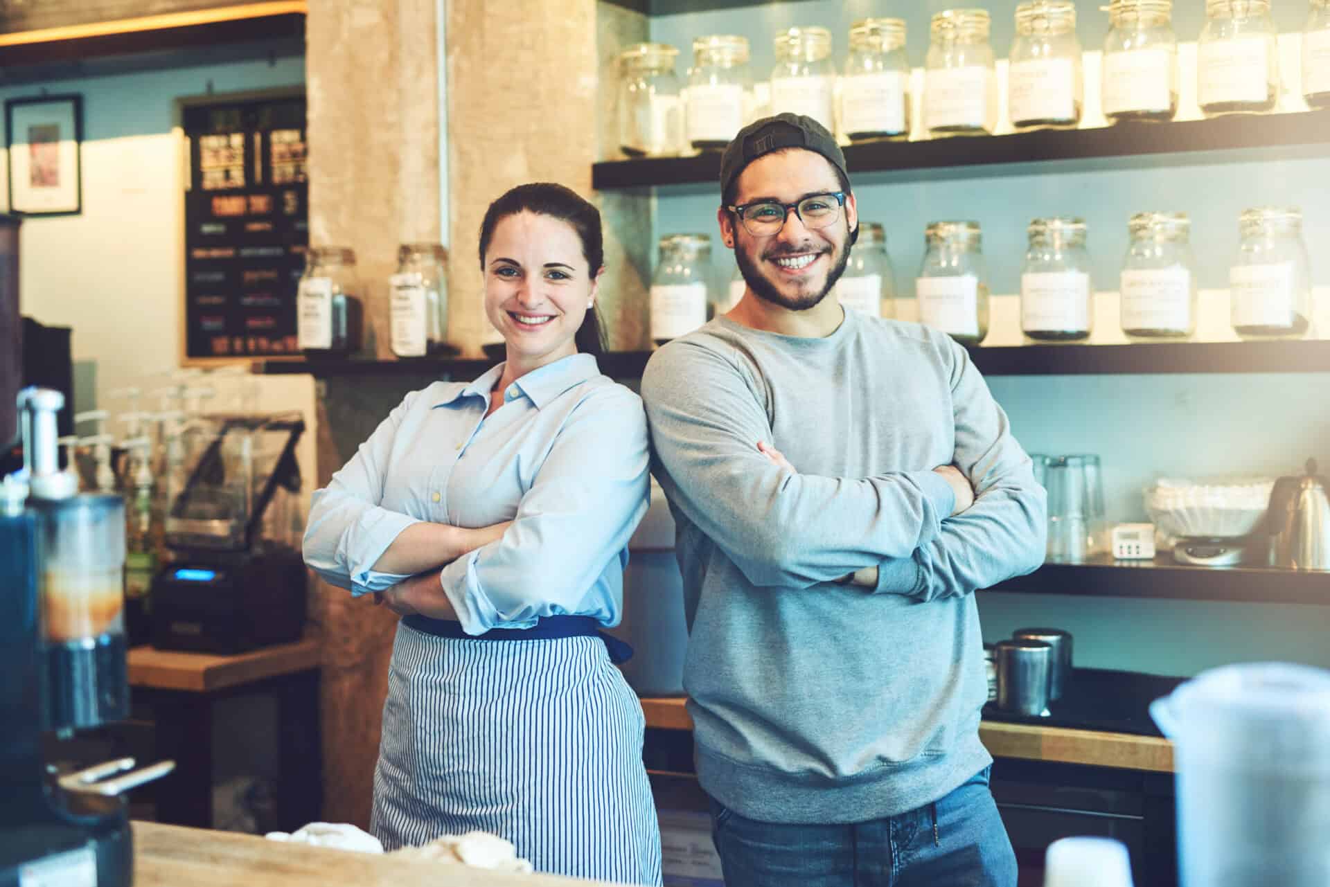 happy-business-owners-standing-proudly-at-coffee